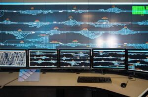 A train station control center with video wall technology. Learn about video walls at CenturyAV.com.
