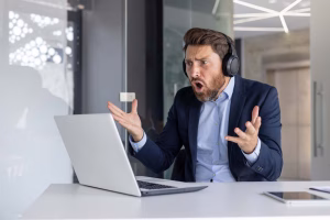 A sales manager panics and cries out as his virtual meeting drops off during a sales call.